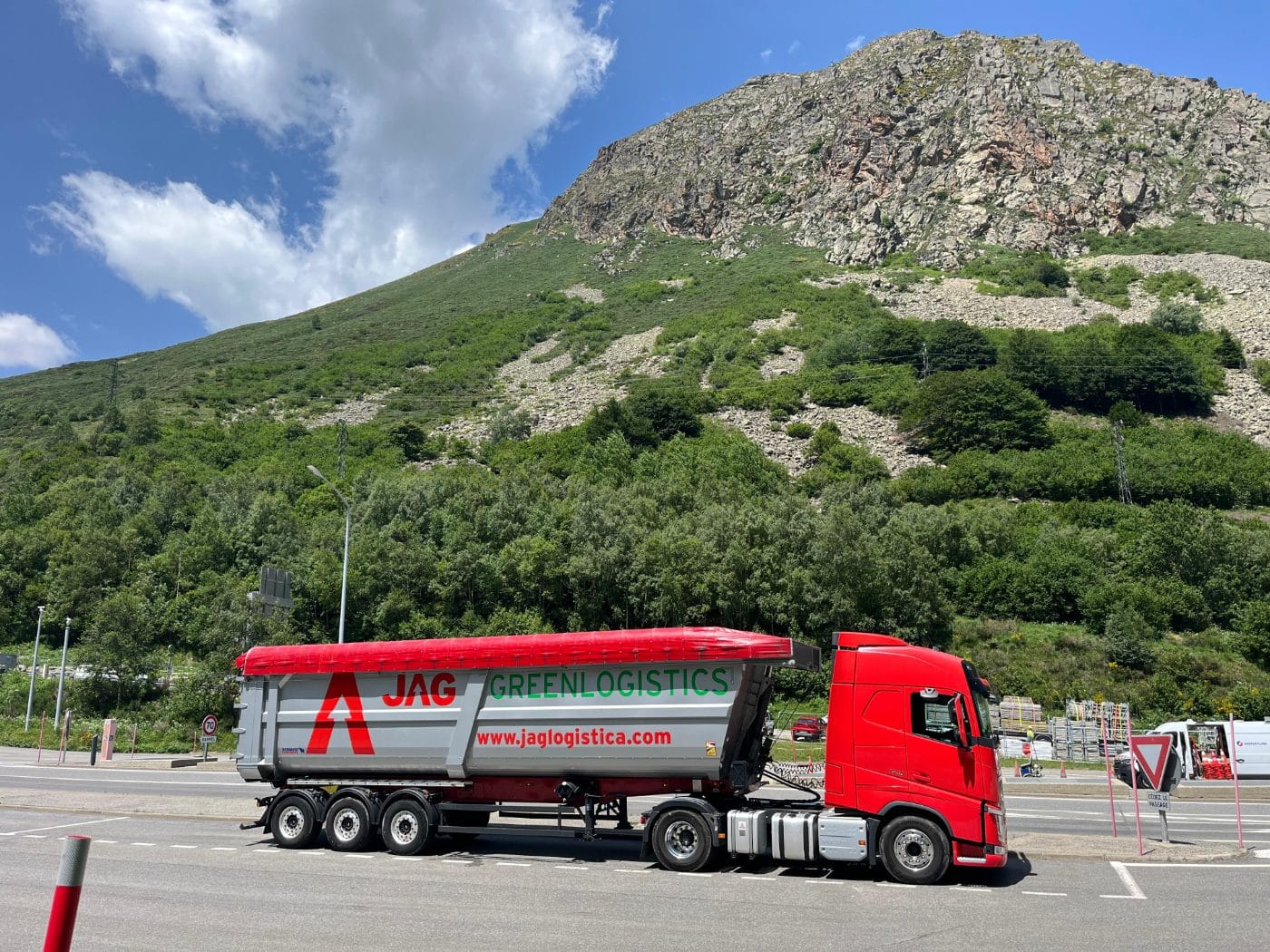 JAG truck with a tipper semi-trailer at a mountain pass